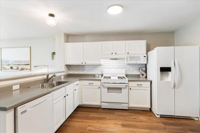 161 Buttercup Way, Kyle, TX 78640 - kitchen with white appliances, under cabinet range hood, white cabinetry, and decorative backsplash
