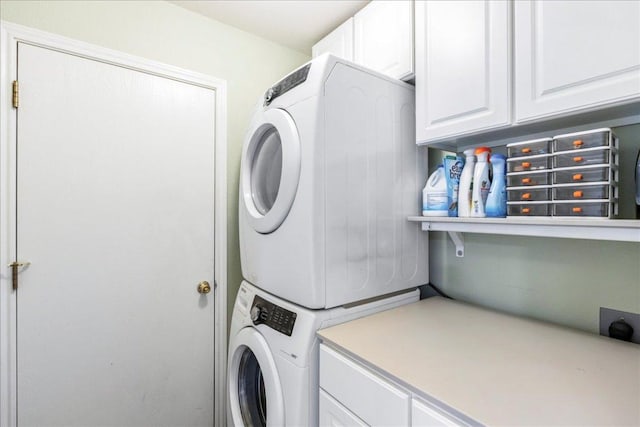 161 Buttercup Way, Kyle, TX 78640 - laundry room featuring stacked washer / drying machine and cabinet space