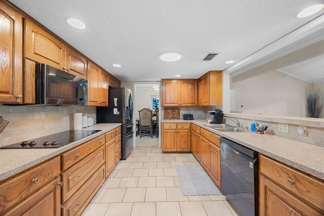 9202 Spring Hollow Dr, Austin, TX 78750 - kitchen featuring black appliances, backsplash, brown cabinets, light countertops, and recessed lighting
