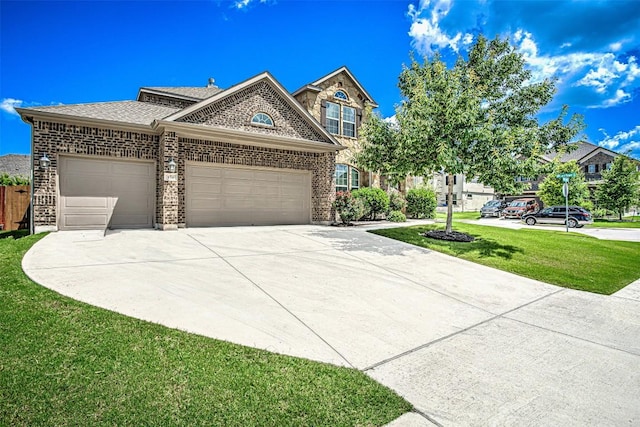 536 Middle Brook Dr, Leander, TX 78641 - view of front of home featuring a garage, concrete driveway, brick siding, a front lawn, and a shingled roof