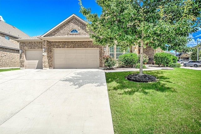 536 Middle Brook Dr, Leander, TX 78641 - view of front of home featuring a garage, a front yard, concrete driveway, and brick siding