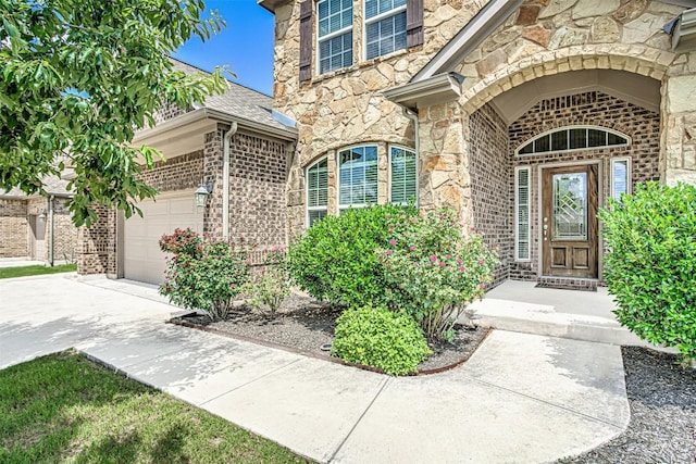 536 Middle Brook Dr, Leander, TX 78641 - entrance to property with stone siding, a garage, driveway, and brick siding