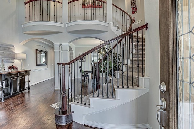 536 Middle Brook Dr, Leander, TX 78641 - entryway featuring decorative columns, a towering ceiling, arched walkways, wood finished floors, and stairway