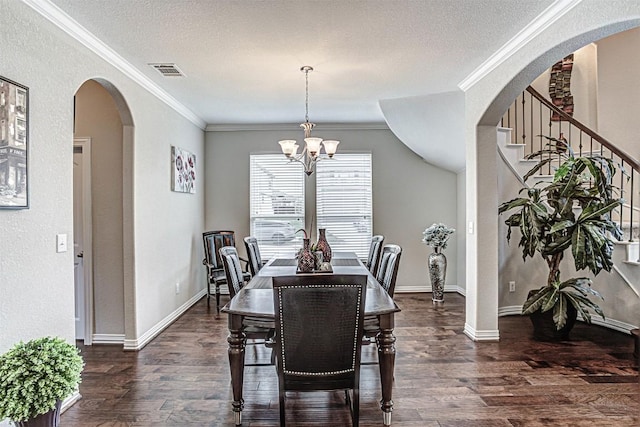536 Middle Brook Dr, Leander, TX 78641 - dining room with a chandelier, ornamental molding, wood finished floors, a textured ceiling, and arched walkways