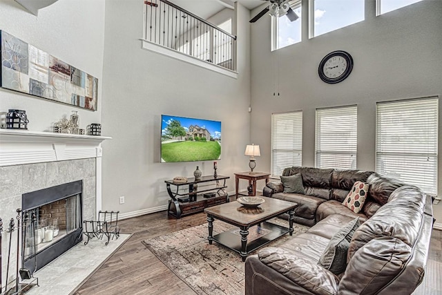 536 Middle Brook Dr, Leander, TX 78641 - living room with a towering ceiling, wood finished floors, a ceiling fan, and a tiled fireplace