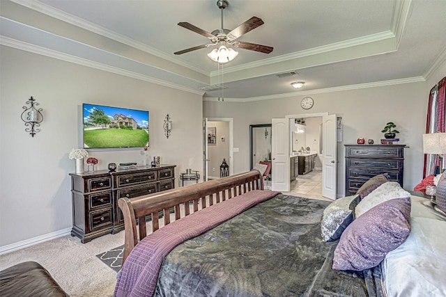 536 Middle Brook Dr, Leander, TX 78641 - bedroom featuring a tray ceiling, ornamental molding, ceiling fan, connected bathroom, and light colored carpet