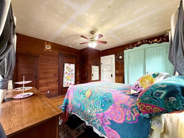 935 E Upper Line St, La Grange, TX 78945 - bedroom featuring wooden walls, wood finished floors, and ceiling fan