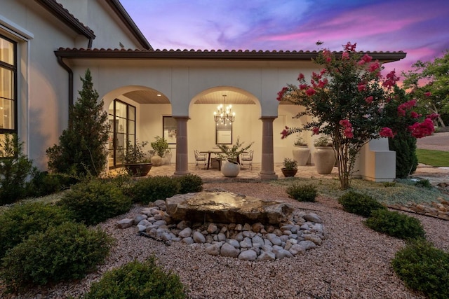 4716 Peralta Ln, Austin, TX 78735 - back of property at dusk featuring a patio and stucco siding