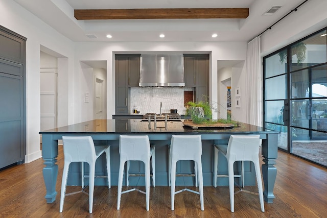 4716 Peralta Ln, Austin, TX 78735 - kitchen featuring wall chimney exhaust hood, backsplash, dark wood-style flooring, recessed lighting, and beamed ceiling