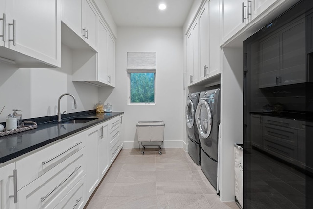 4716 Peralta Ln, Austin, TX 78735 - laundry area featuring independent washer and dryer, cabinet space, recessed lighting, and light tile patterned floors