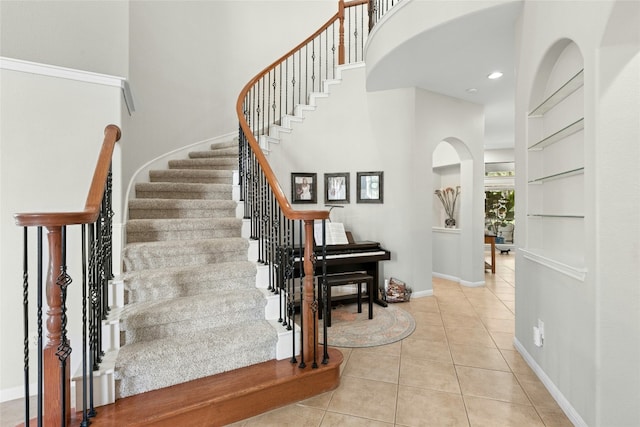 11104 Claro Vista Cv, Austin, TX 78739 - staircase featuring a towering ceiling, tile patterned flooring, and recessed lighting
