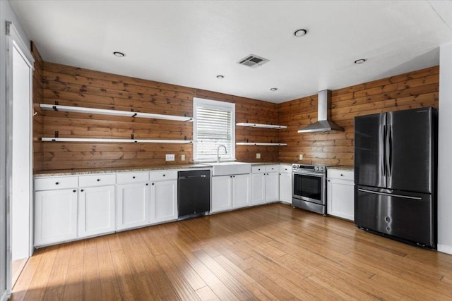 18000 Lafayette Park Rd, Jonestown, TX 78645 - kitchen with black appliances, open shelves, wall chimney range hood, wooden walls, and white cabinets