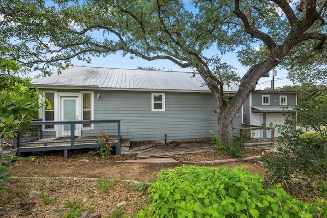 18000 Lafayette Park Rd, Jonestown, TX 78645 - rear view of property featuring a metal roof, a deck, and an attached garage
