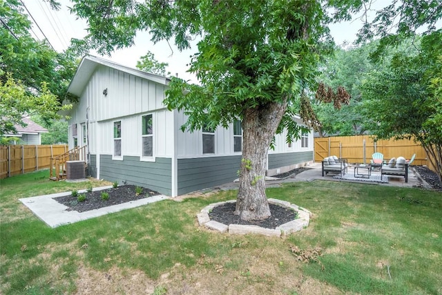 5714 Ave D, Austin, TX 78752 - rear view of house featuring a fenced backyard, a patio, an outdoor living space, and board and batten siding