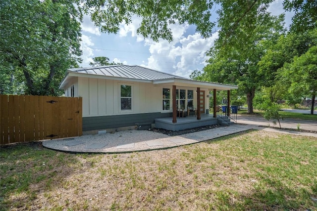 5714 Ave D, Austin, TX 78752 - rear view of property with board and batten siding, a metal roof, and crawl space