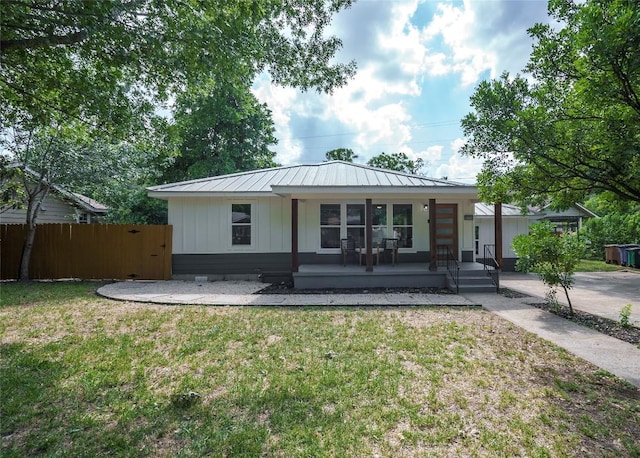 5714 Ave D, Austin, TX 78752 - view of front of home featuring a porch, a metal roof, board and batten siding, and a standing seam roof