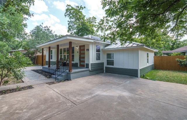 5714 Ave D, Austin, TX 78752 - view of front of home with a porch, board and batten siding, and driveway
