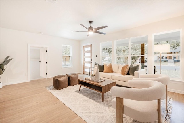 5714 Ave D, Austin, TX 78752 - living room with light wood finished floors, healthy amount of natural light, and a ceiling fan