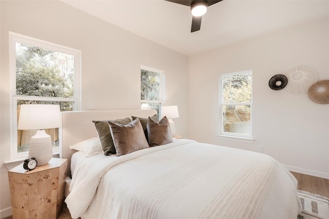 5714 Ave D, Austin, TX 78752 - bedroom with multiple windows, wood finished floors, and ceiling fan