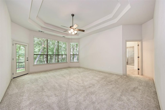 1160 Waimea Bnd, Round Rock, TX 78681 - unfurnished room featuring a ceiling fan, a tray ceiling, and carpet floors