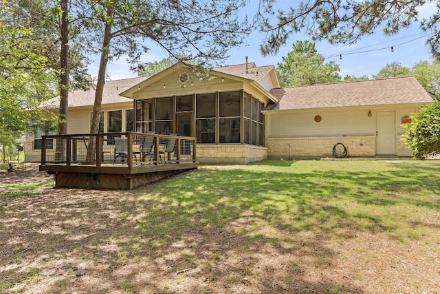 236 Pony Express Dr, Smithville, TX 78957 - back of house featuring a sunroom, a wooden deck, a yard, and a shingled roof