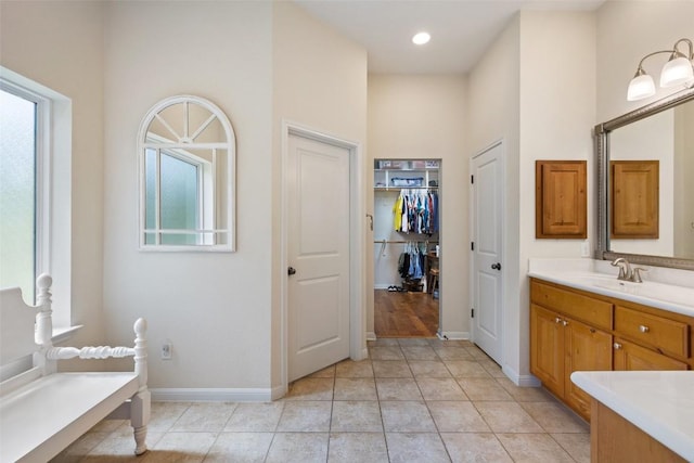 236 Pony Express Dr, Smithville, TX 78957 - bathroom featuring vanity, a high ceiling, tile patterned floors, and a spacious closet