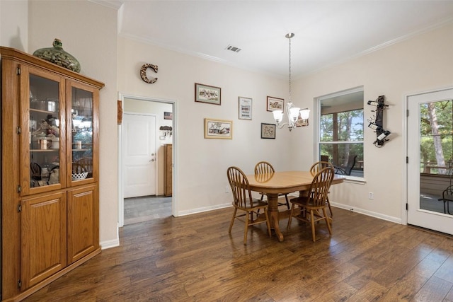 236 Pony Express Dr, Smithville, TX 78957 - dining space featuring crown molding, dark wood-type flooring, and a chandelier