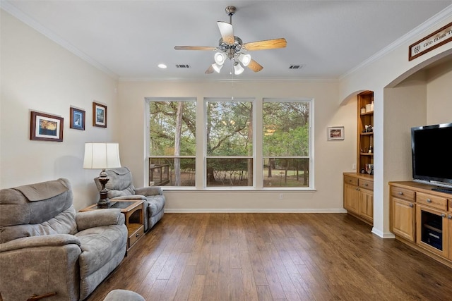 236 Pony Express Dr, Smithville, TX 78957 - living room with a ceiling fan, dark wood-style floors, ornamental molding, arched walkways, and recessed lighting
