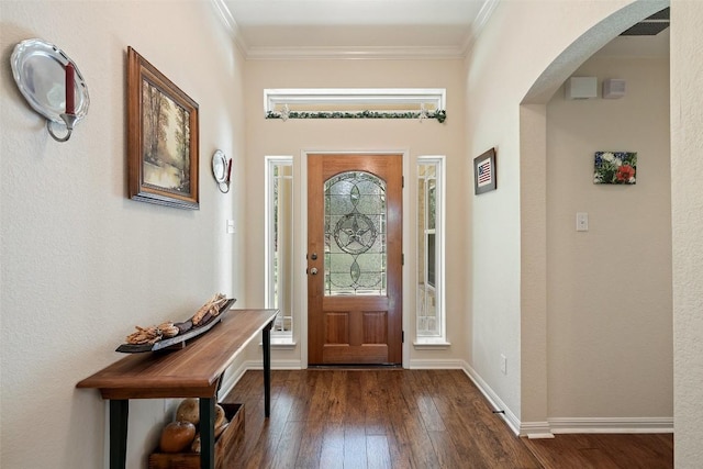 236 Pony Express Dr, Smithville, TX 78957 - foyer entrance featuring arched walkways, dark wood-style floors, and crown molding