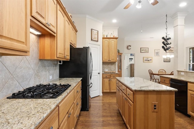 236 Pony Express Dr, Smithville, TX 78957 - kitchen with black appliances, a kitchen island, a ceiling fan, tasteful backsplash, and light stone counters
