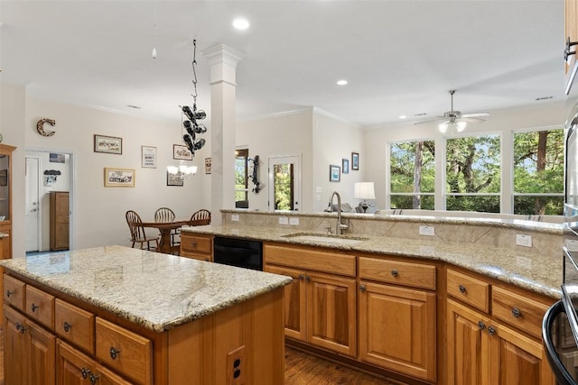 236 Pony Express Dr, Smithville, TX 78957 - kitchen featuring a ceiling fan, dishwasher, light stone counters, brown cabinetry, and recessed lighting