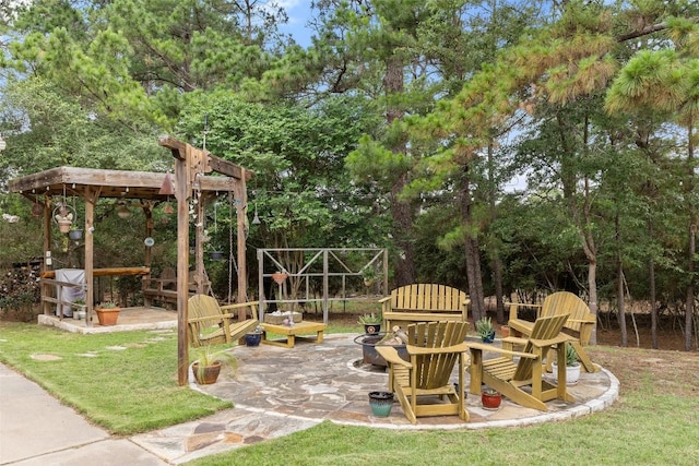 236 Pony Express Dr, Smithville, TX 78957 - view of yard featuring an outdoor fire pit, a patio area, and view of wooded area