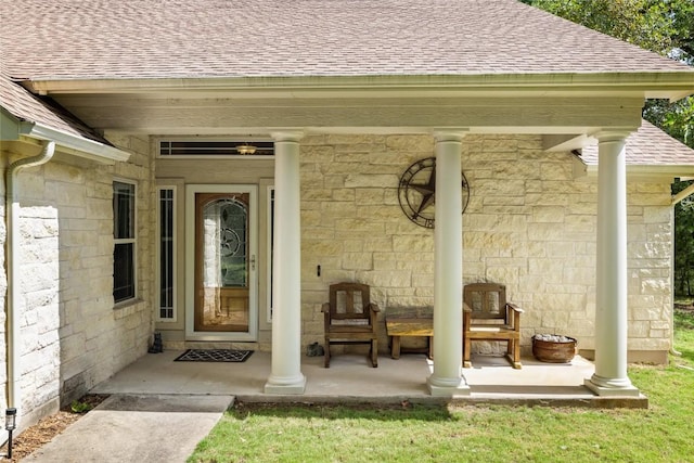 236 Pony Express Dr, Smithville, TX 78957 - view of exterior entry with a shingled roof, stone siding, and a porch