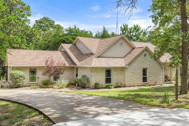 236 Pony Express Dr, Smithville, TX 78957 - traditional home featuring stone siding, a shingled roof, and a front yard
