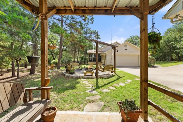 236 Pony Express Dr, Smithville, TX 78957 - view of grassy yard featuring an outdoor structure, concrete driveway, an outdoor living space, and a patio