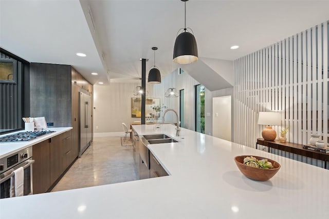 1327 Bonham Ter Unit B, Austin, TX 78704 - kitchen featuring stainless steel appliances, light countertops, modern cabinets, decorative light fixtures, and recessed lighting