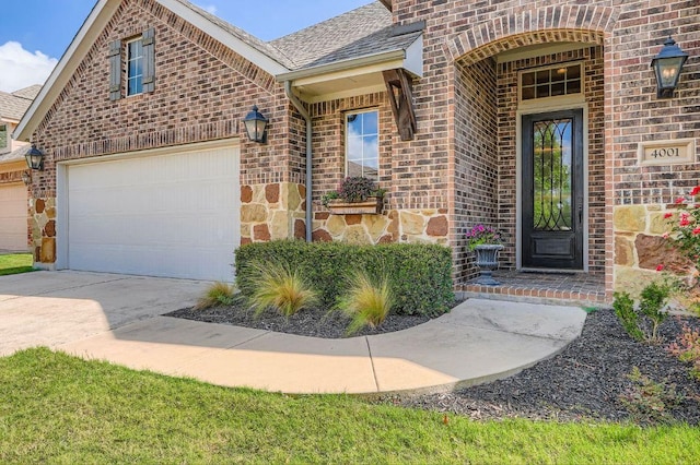 4001 Discovery Well Dr, Liberty Hill, TX 78642 - entrance to property featuring brick siding, concrete driveway, and roof with shingles