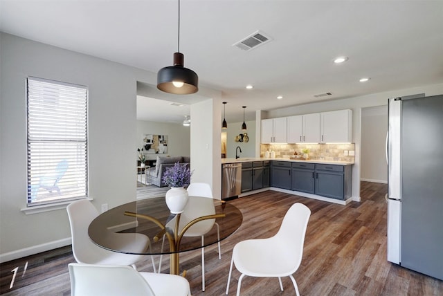 1109 Minerva St, Austin, TX 78753 - dining space featuring dark wood-type flooring and recessed lighting