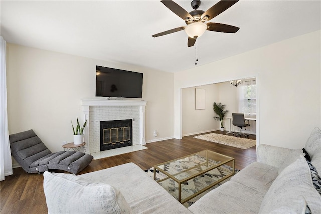 5910 Abilene Trl, Austin, TX 78749 - living area with ceiling fan, wood finished floors, a brick fireplace, and a chandelier