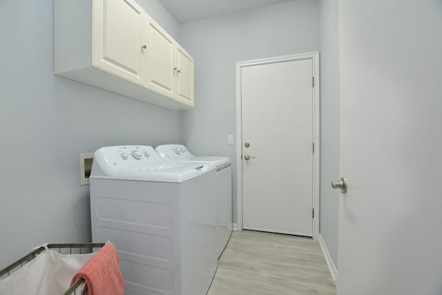 106 Bass St, Georgetown, TX 78633 - laundry area with cabinet space, washer and dryer, and light wood-type flooring