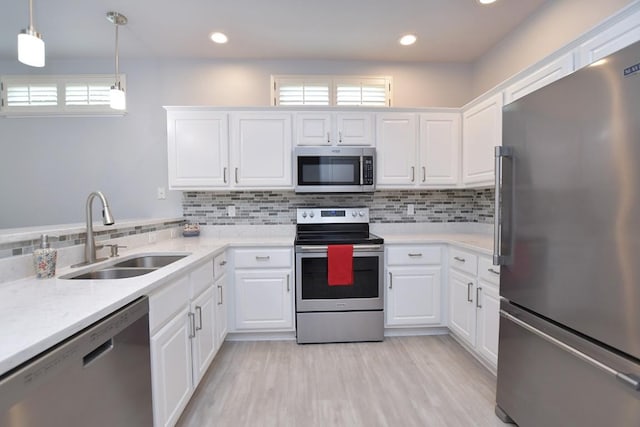106 Bass St, Georgetown, TX 78633 - kitchen with appliances with stainless steel finishes, light countertops, white cabinetry, backsplash, and recessed lighting