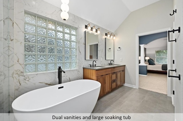 8300 Fern Bluff Ave, Round Rock, TX 78681 - ensuite bathroom featuring a freestanding bath, double vanity, and vaulted ceiling