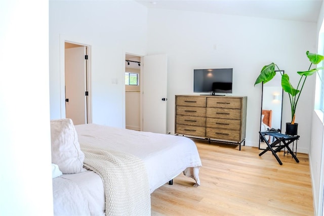 4407 Ganymede Dr, Austin, TX 78727 - bedroom featuring light wood-style flooring and a towering ceiling