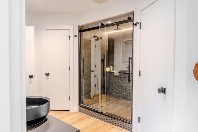 4407 Ganymede Dr, Austin, TX 78727 - full bathroom with a shower stall and wood finished floors