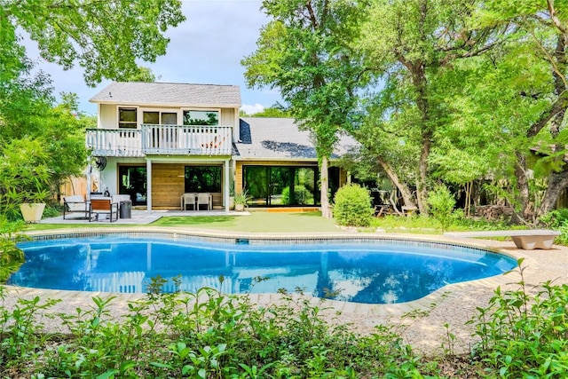 4407 Ganymede Dr, Austin, TX 78727 - rear view of property with an outdoor pool, a patio, and a wooden deck