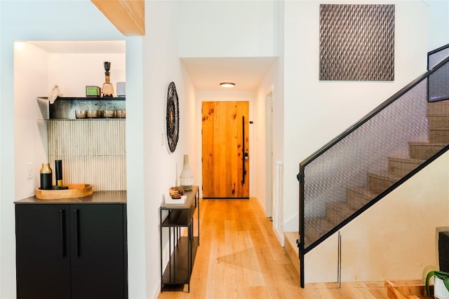 4407 Ganymede Dr, Austin, TX 78727 - entryway with a dry bar, light wood-type flooring, and stairs