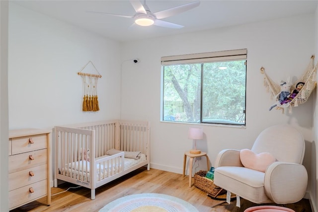 4407 Ganymede Dr, Austin, TX 78727 - bedroom featuring a crib, wood finished floors, and ceiling fan