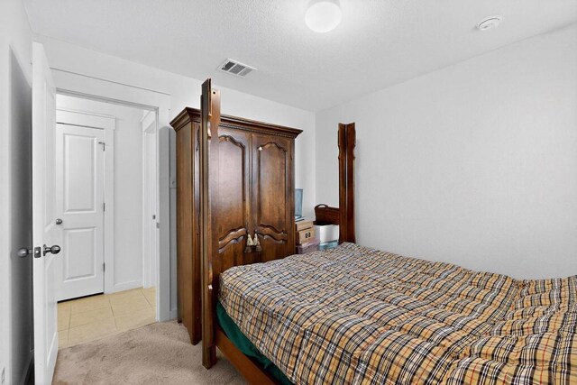 7619 Europa Ave, Round Rock, TX 78665 - bedroom featuring light carpet and light tile patterned flooring