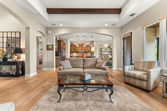 9 Borello Dr Unit 9, Austin, TX 78738 - living room with arched walkways, light wood-type flooring, beamed ceiling, and recessed lighting