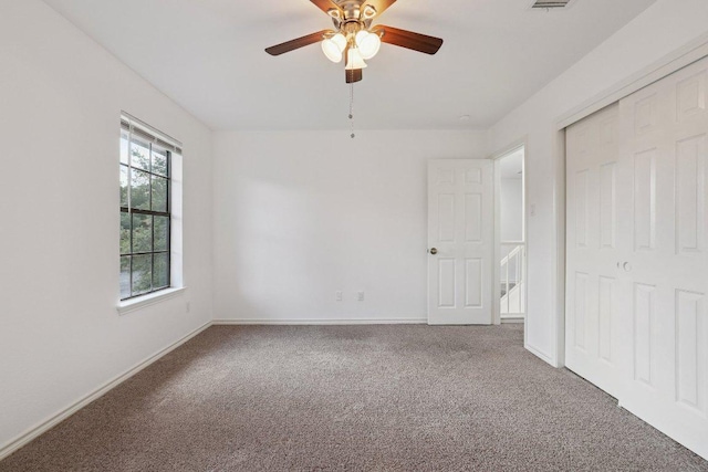 12706 Shemya Cv, Austin, TX 78729 - unfurnished bedroom with carpet, a closet, and a ceiling fan